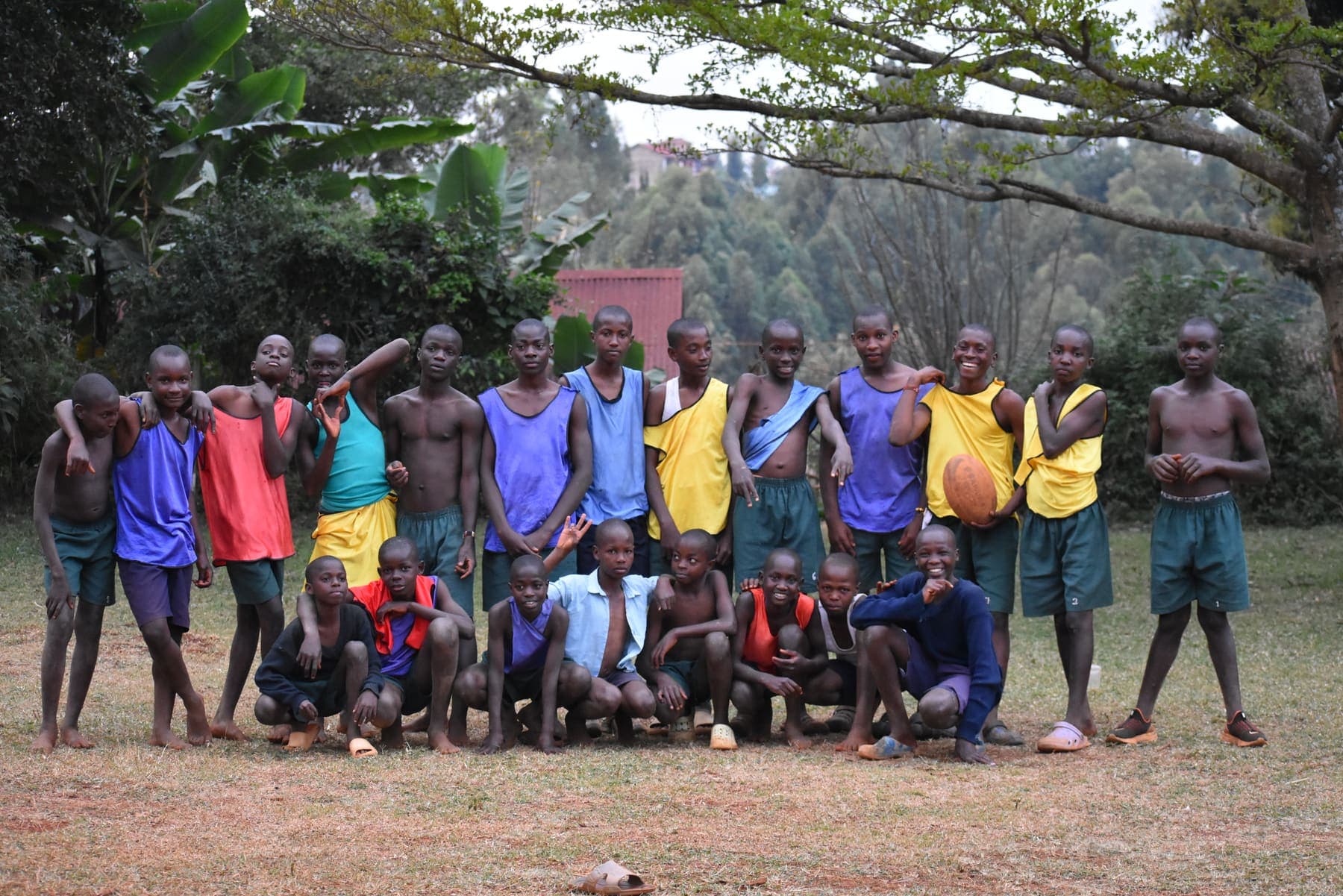 The squad gathered for a group photograph in two rows, standing and crouching, with a rugby ball held at the front.